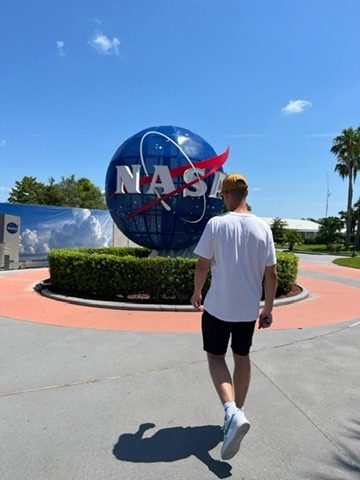 Theo walking toward the NASA globe at Kennedy Space Center