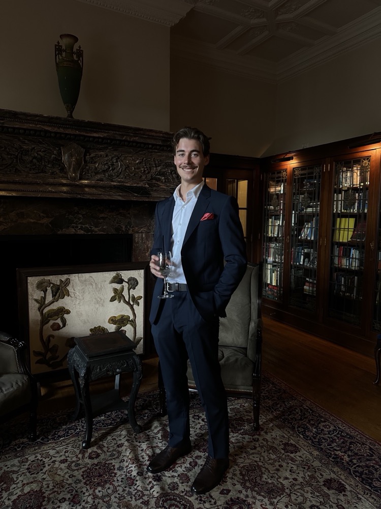 Théo Schiano in a navy suit at an evening event